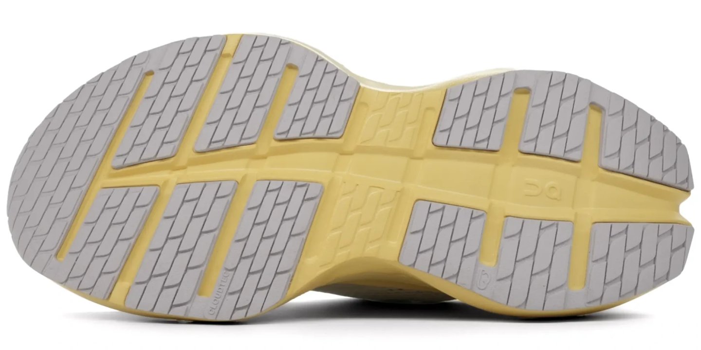 Bottom view of the On Cloudrunner 3 running shoe outsole showing CloudTec rubber lug zones in grey and pale yellow