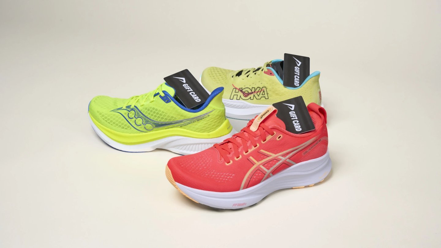 Three running shoes in lime green, yellow, and coral-red from Saucony, HOKA, and ASICS, each tagged with a gift card.