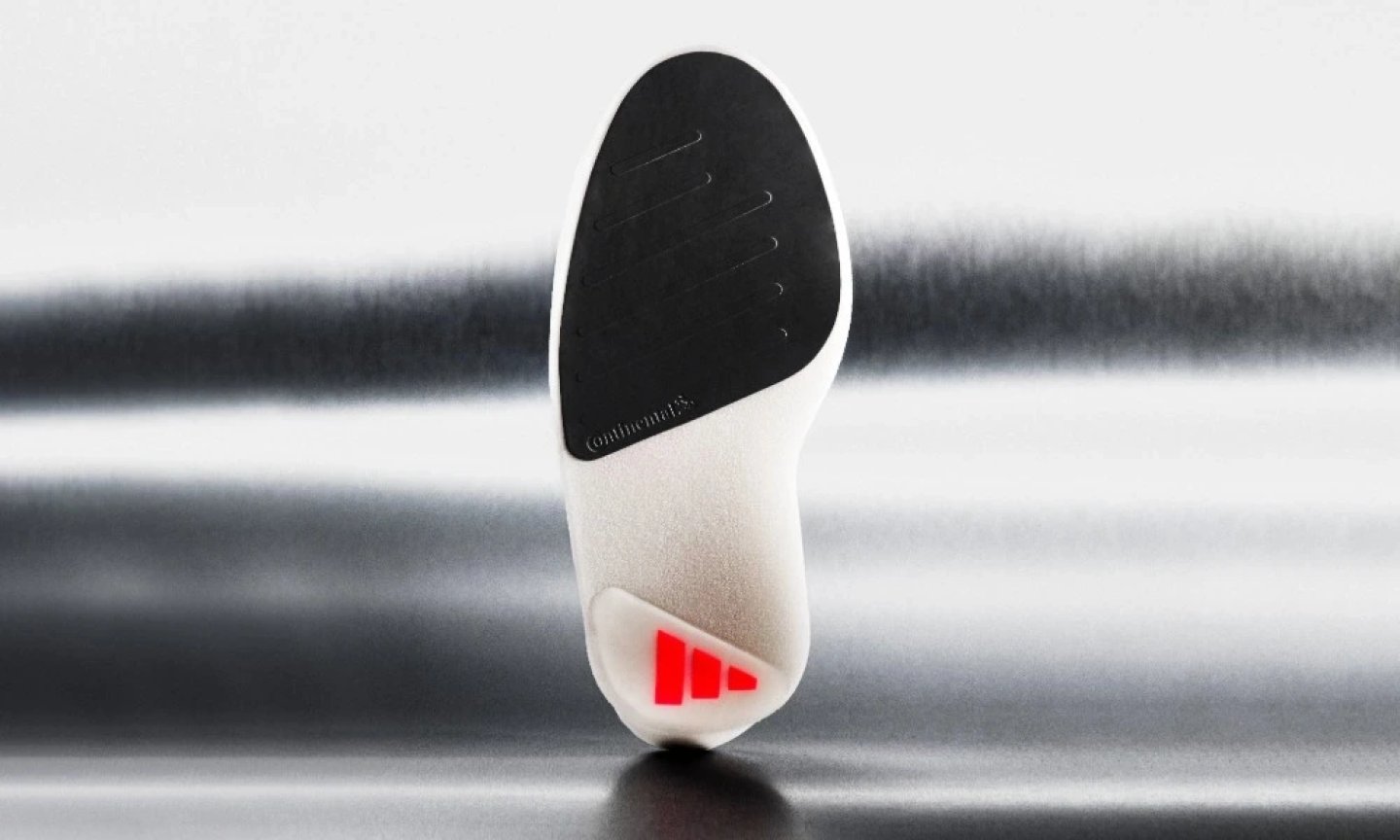 Bottom view of Adidas Adizero Adios Pro Evo 3 showing black Continental rubber outsole and white midsole with red Adidas logo