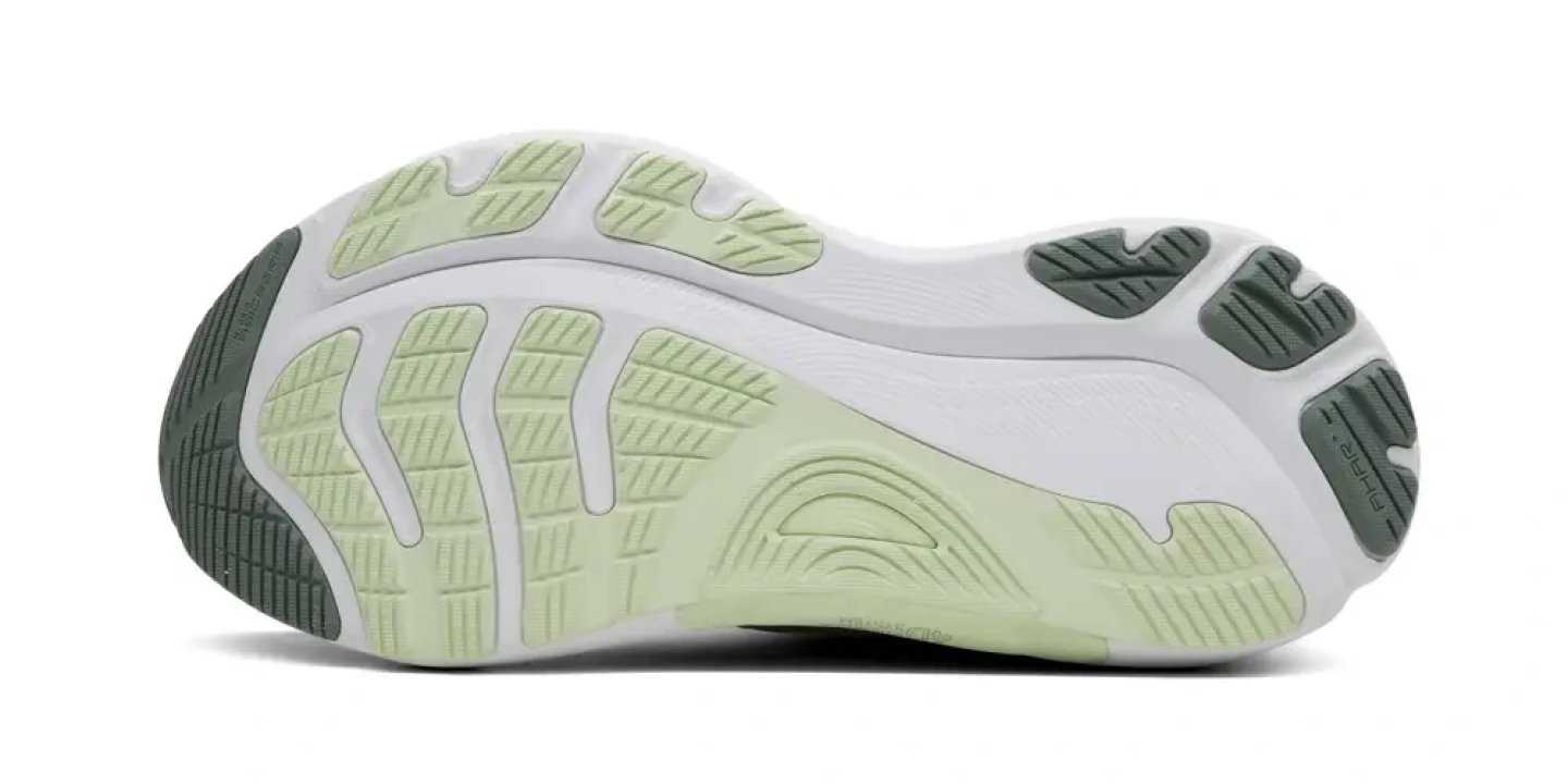 Bottom view of ASICS Gel-Kayano 32 running shoe outsole showing light green and dark green rubber zones with flex grooves