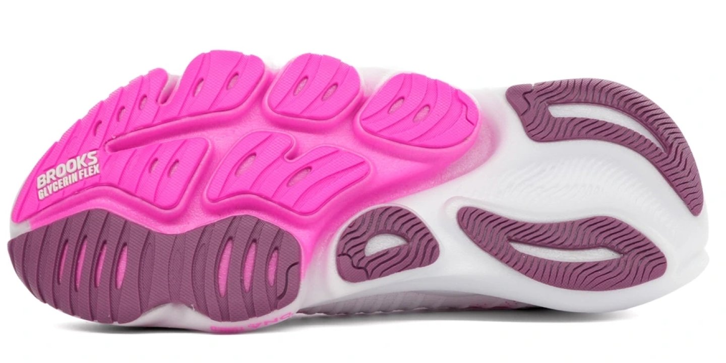 Bottom view of the Brooks Glycerin Flex running shoe outsole in pink and mauve with segmented rubber traction pods and flex grooves.
