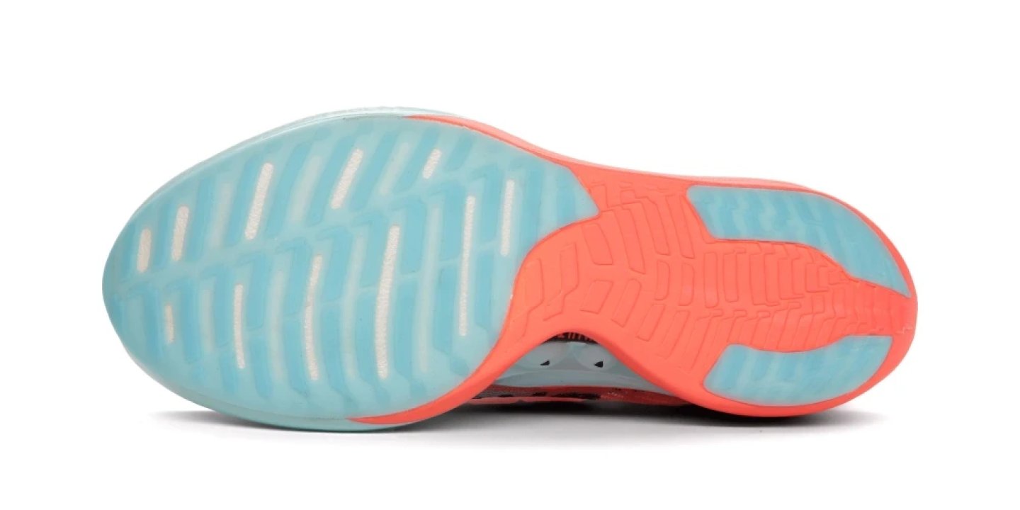 Bottom view of the Brooks Hyperion Elite 4 running shoe outsole with aqua blue rubber and coral forefoot traction zones.