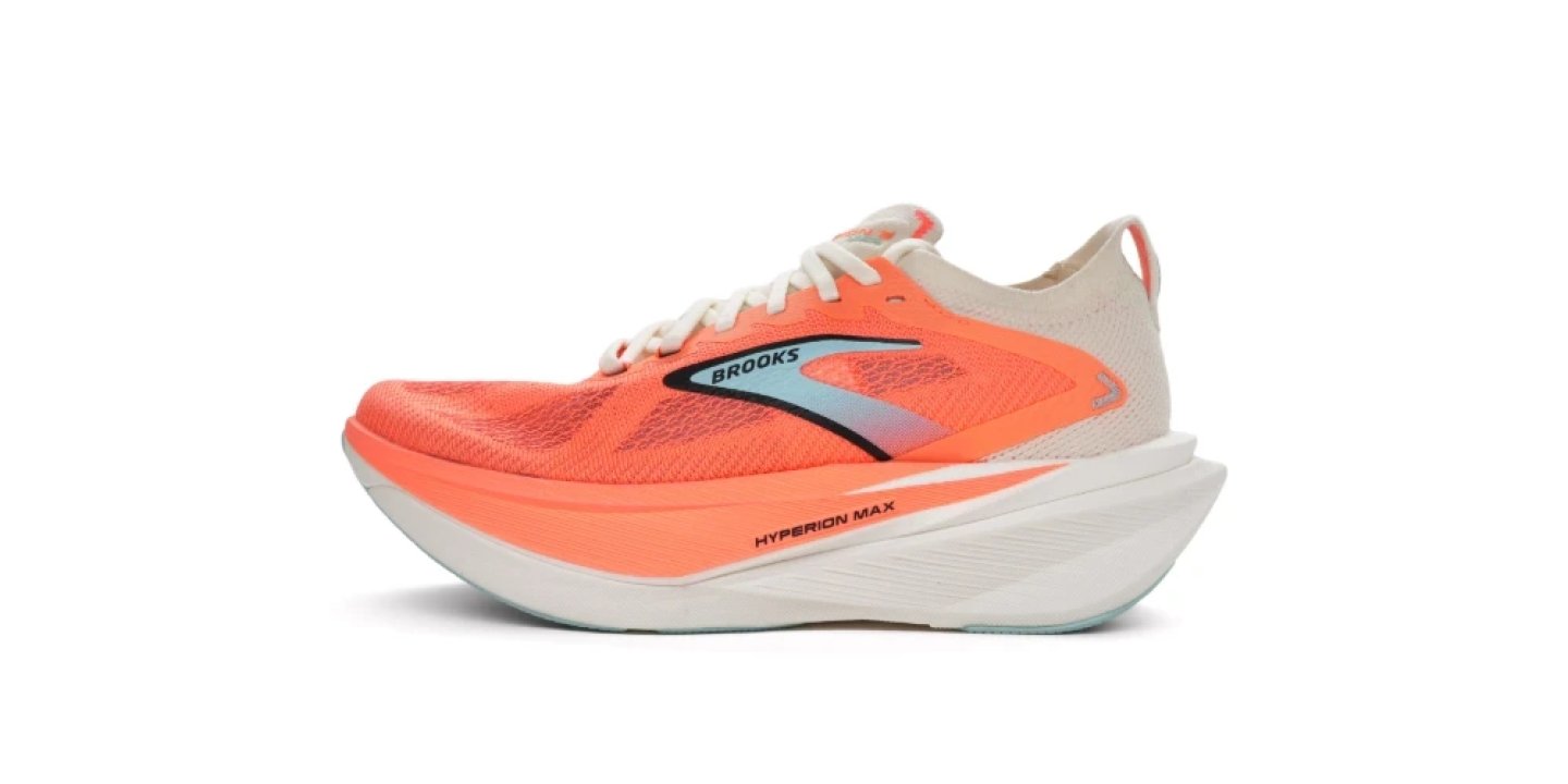 Brooks Hyperion Max running shoe in coral orange and white with mesh upper and thick curved midsole, side profile view