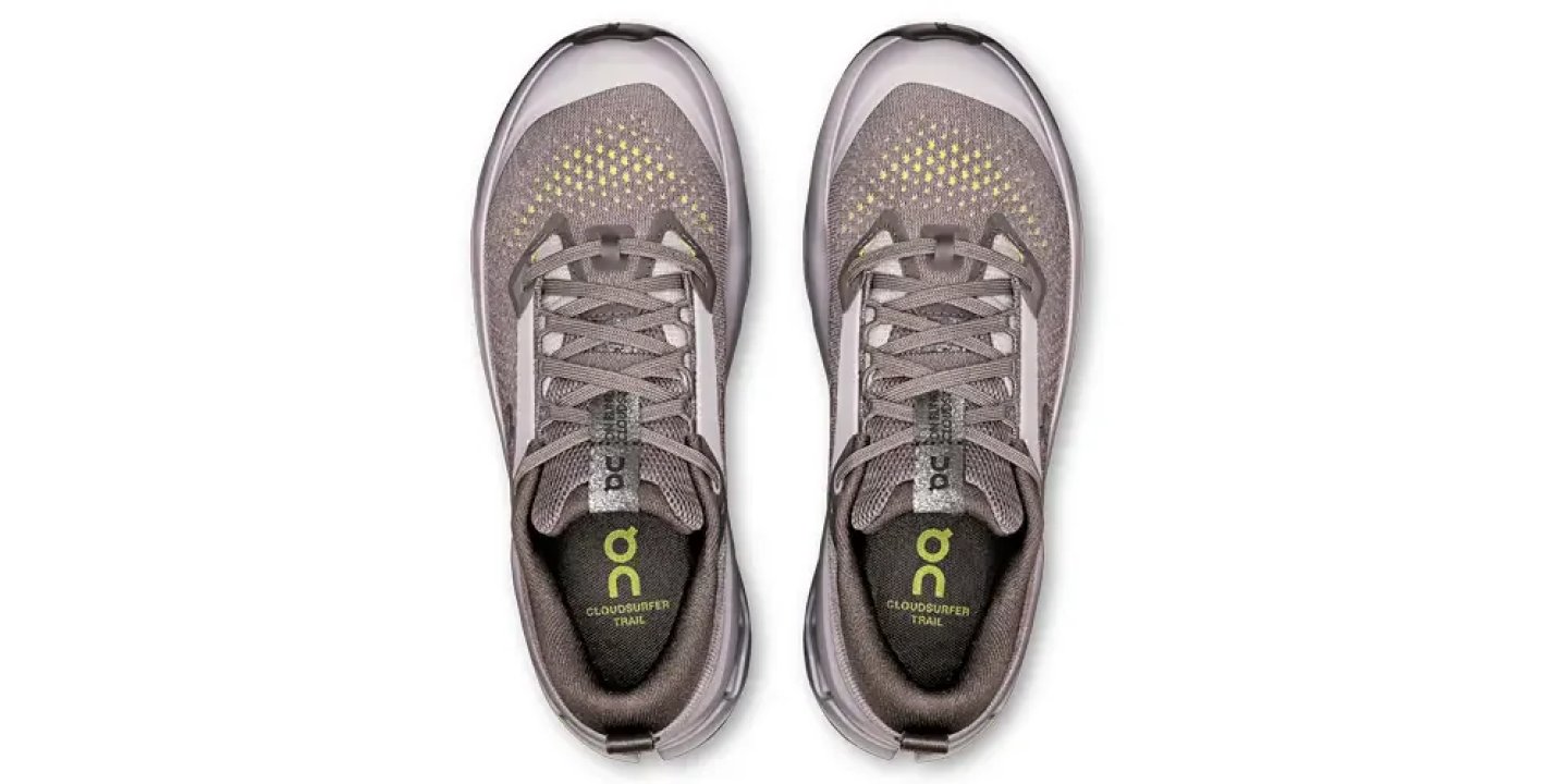 Top-down view of a pair of grey On Cloudsurfer Trail running shoes with lime-yellow mesh detailing and branded insoles.