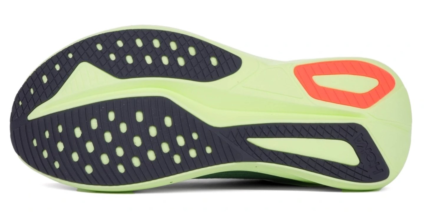 Bottom view of the Hoka Mach 7 running shoe outsole showing dark rubber lugs, lime green midsole and coral heel accent.