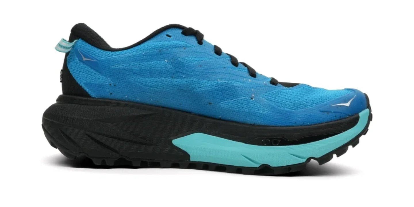 Hoka trail running shoe with blue mesh upper, aqua midsole, and black lugged outsole, lateral side view.