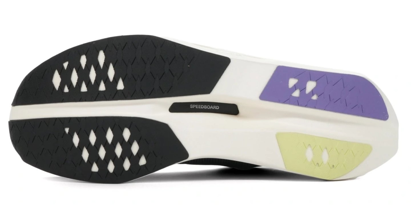 On Cloudboom Volt running shoe outsole showing Speedboard label, diamond-pattern rubber lugs, purple and yellow forefoot grip zones