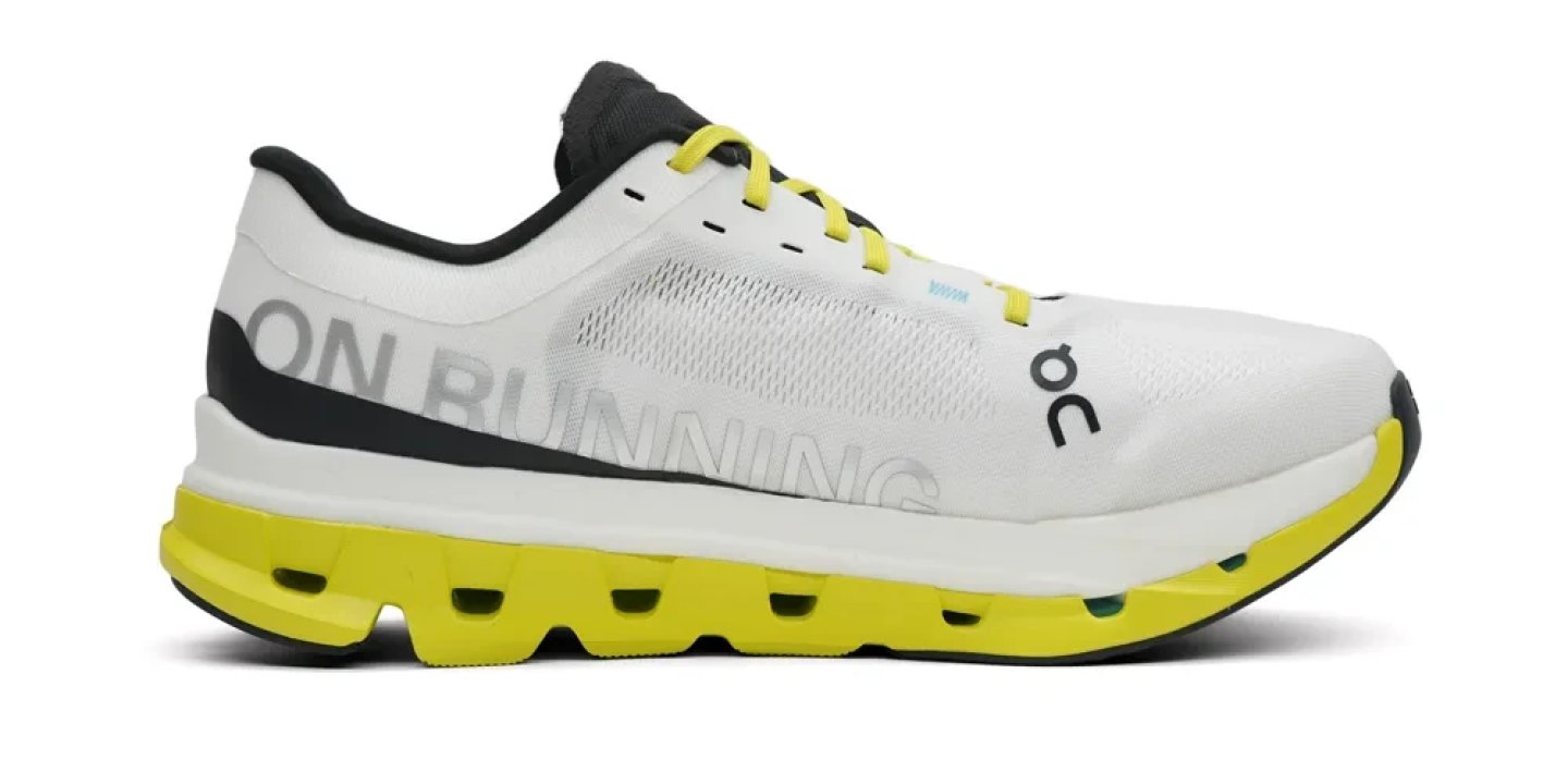 On Running Cloudboom men's running shoe in white and yellow with CloudTec midsole, lateral view on white background