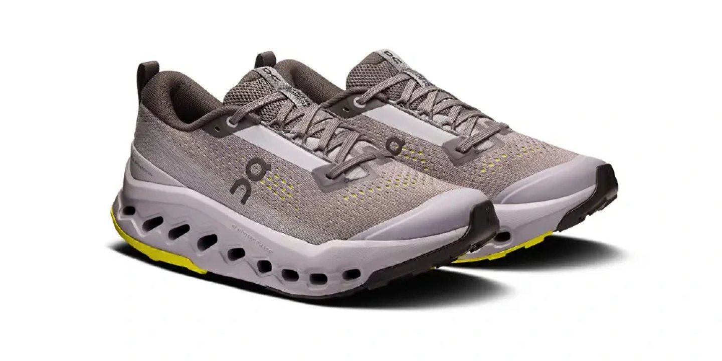 Pair of On Cloudsurfer Trail running shoes in grey with yellow accents and perforated CloudTec midsole