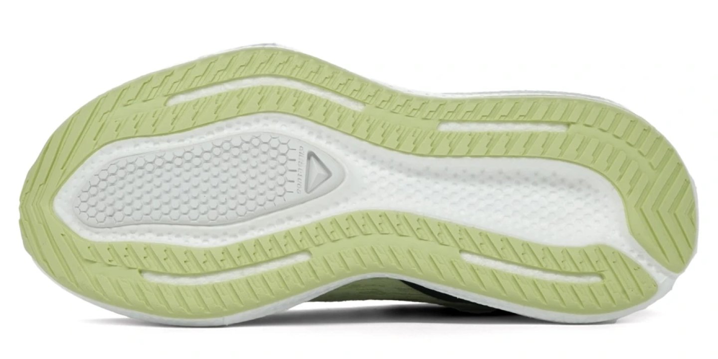 Bottom view of the Salomon Aero Glide 4 running shoe outsole in light green and white with chevron traction lugs