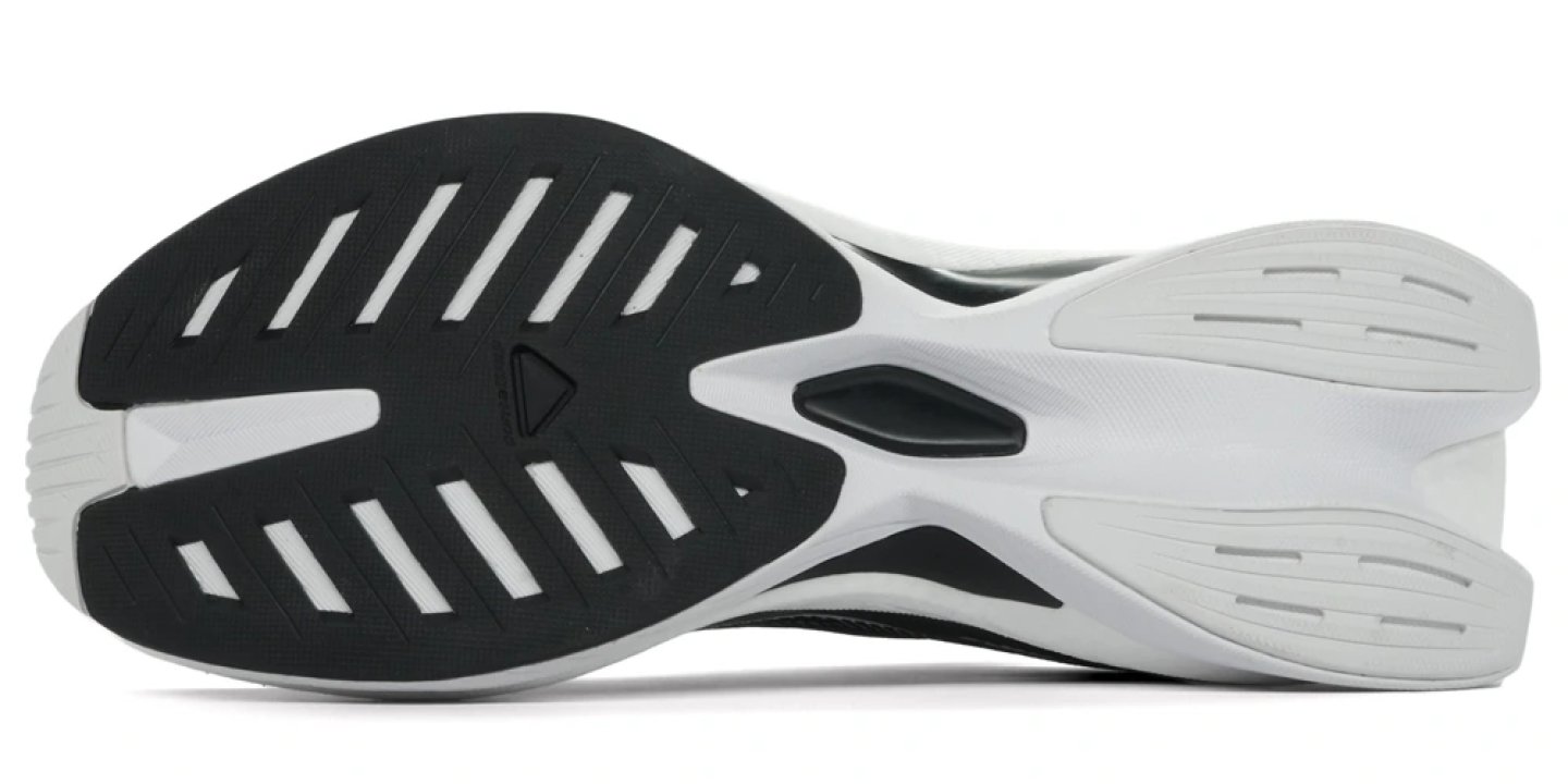 Bottom view of Salomon Spectur 3 running shoe outsole showing black rubber heel zone with diagonal lugs and white forefoot