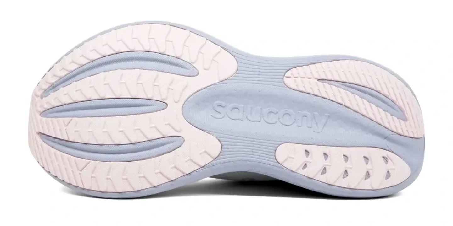 Bottom view of Saucony Triumph 23 running shoe outsole showing segmented rubber lugs in pale pink and light blue