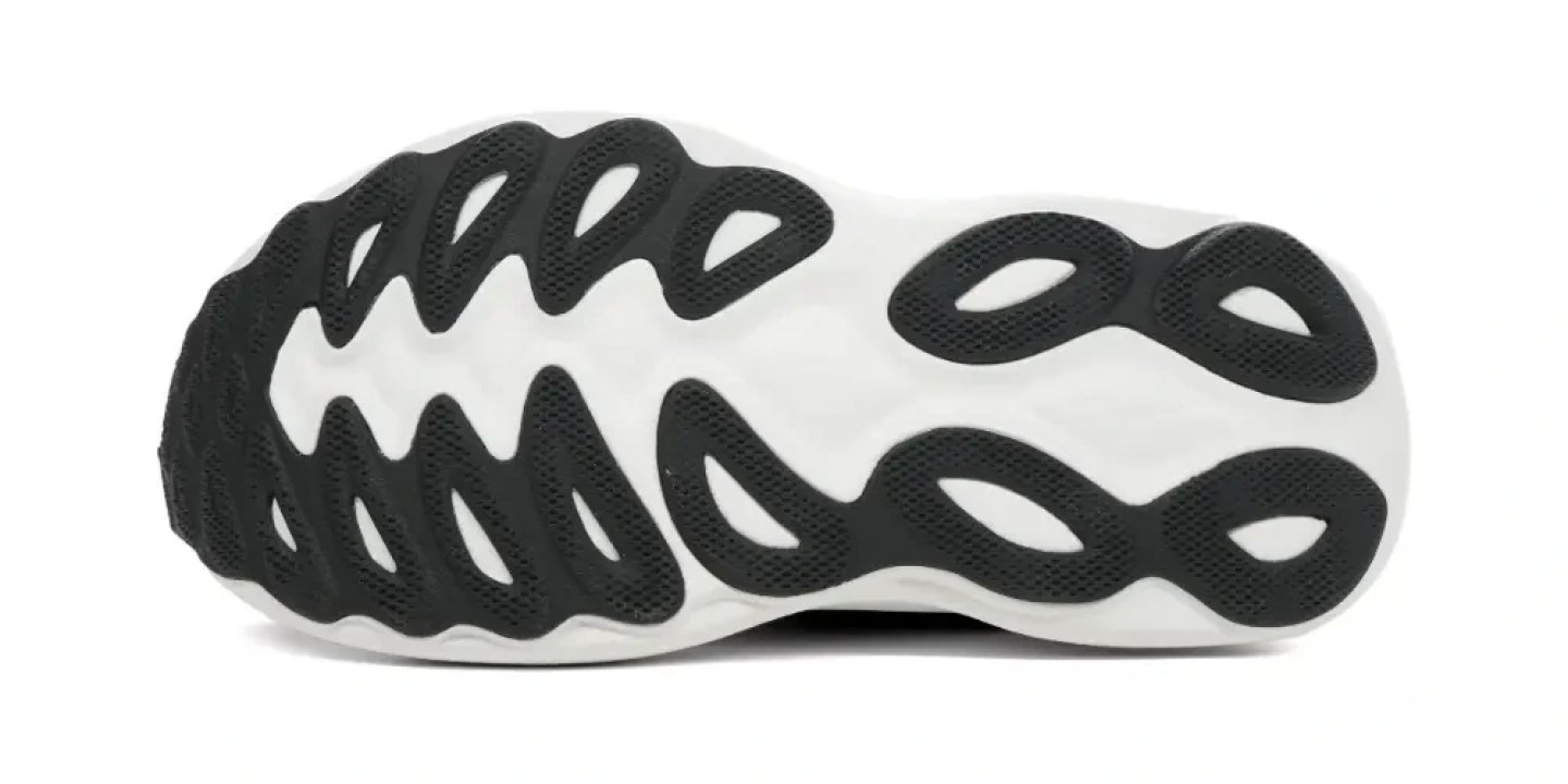 Bottom view of the Mizuno Wave Sky 9 running shoe outsole showing black wave-pattern rubber lugs on a white midsole base.