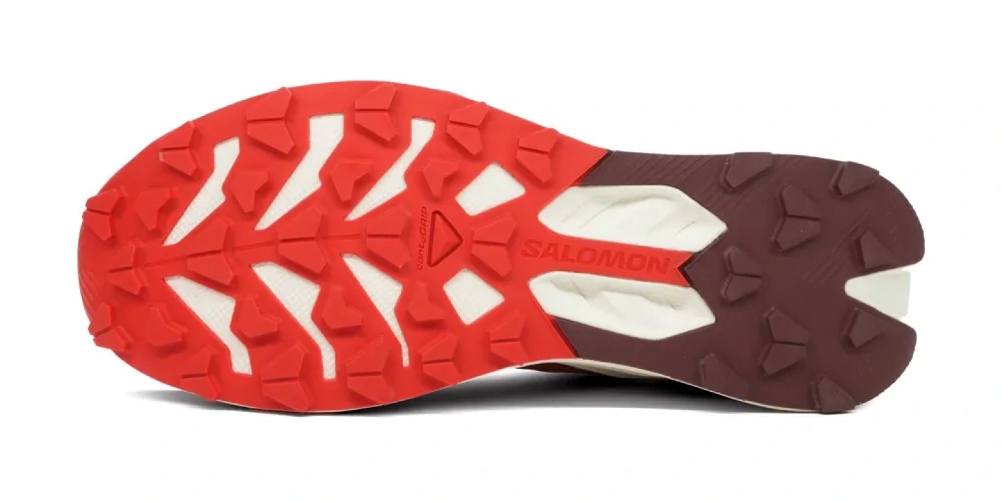 Bottom view of Salomon S/Lab Pulsar 4 trail running shoe outsole showing red and burgundy Contagrip rubber lugs