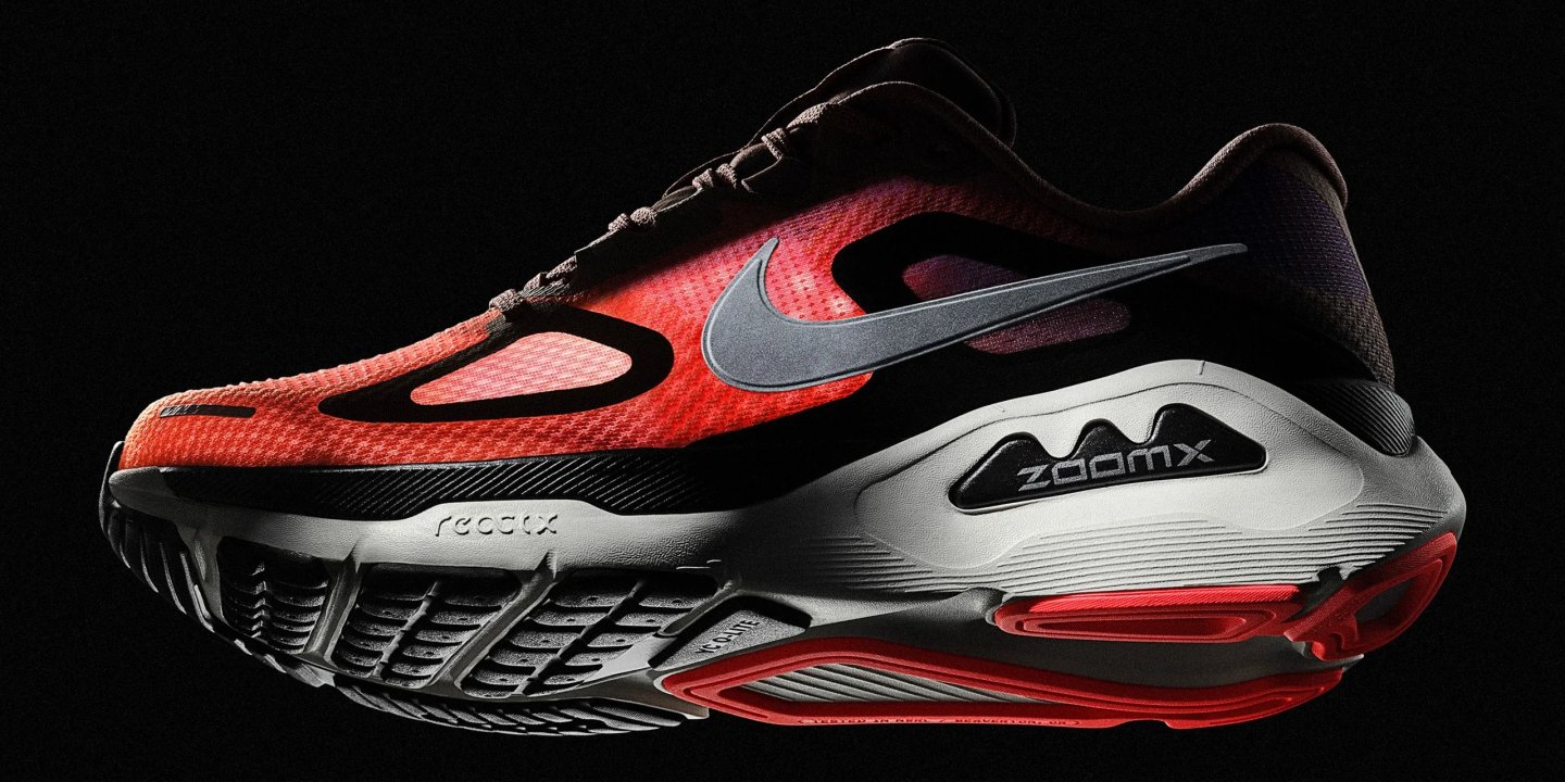 Nike running shoe in red and black with metallic Swoosh, ZoomX and ReactX midsole labelling, lateral view.