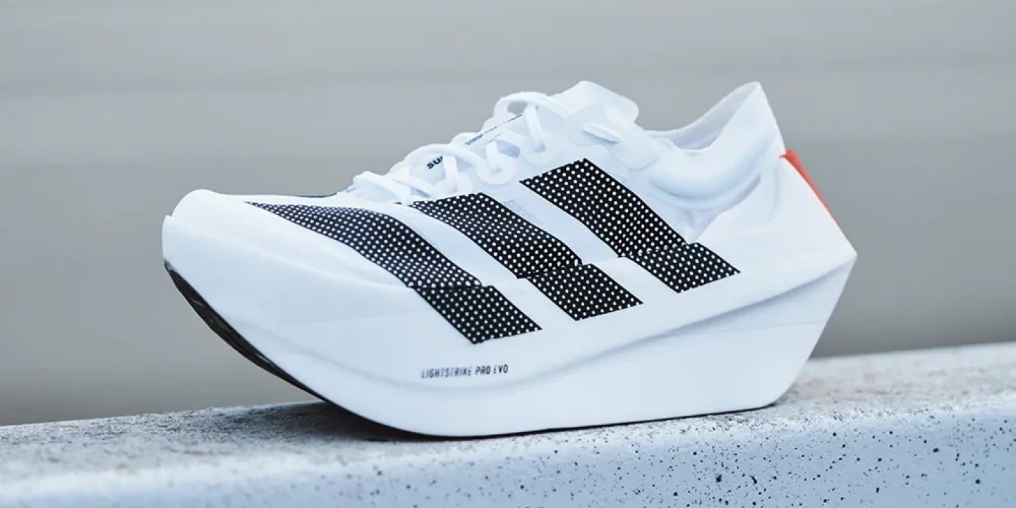 Adidas Adizero Adios Pro Evo 1 in white with black three stripes and orange heel detail, Lightstrike Pro Evo midsole