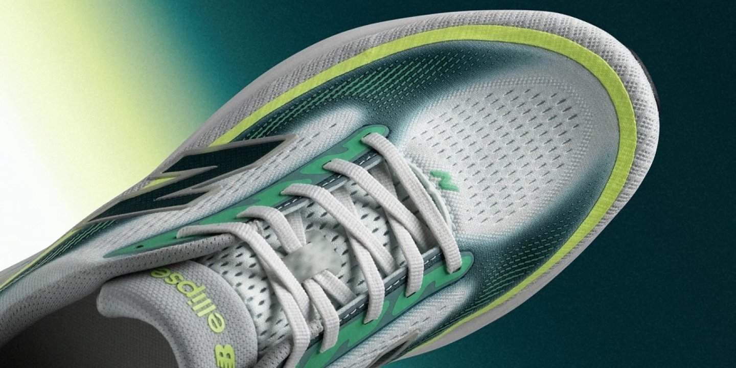 Close-up top view of New Balance Ellipse running shoe in grey with green and lime yellow accents and white laces