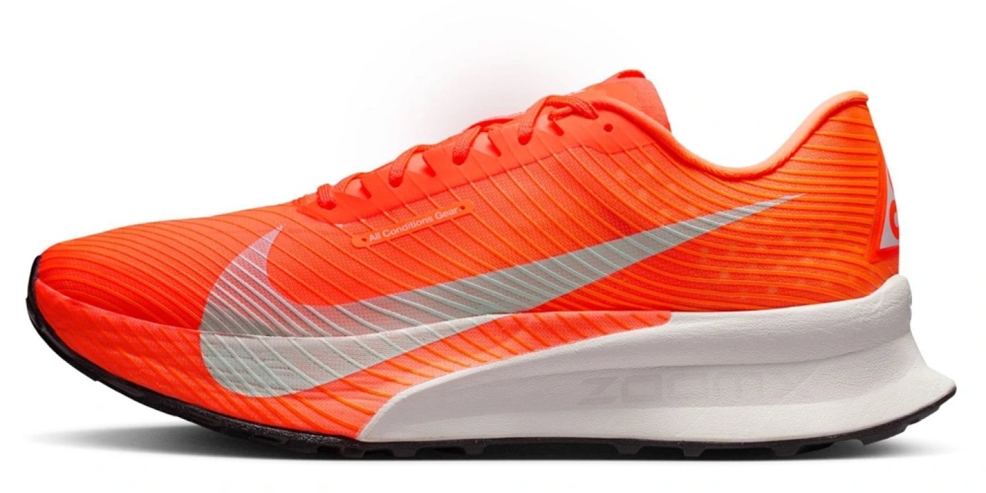 Nike ACG Ultrafly Trail running shoe in orange with white Swoosh and white midsole, lateral side view